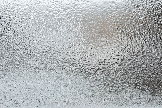 Water condensation on glass demonstrating heat reduction from ceramic tinting film