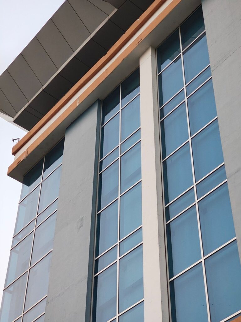 Blue glass commercial building corner featuring solar control window film in New Jersey